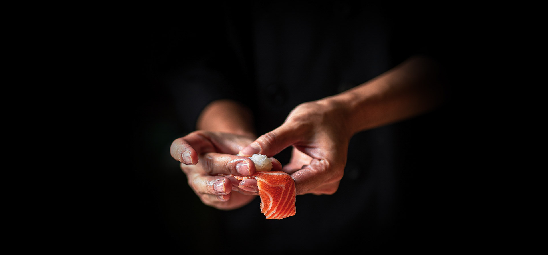 Closeup of chef hands preparing japanese food. Japanese chef mak